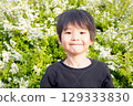 Smiling elementary school boy playing in the park. A lively Japanese child. 129333830