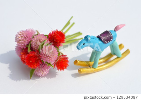 Paper clay rocking horse and globe amaranth New Year's materials 129334087