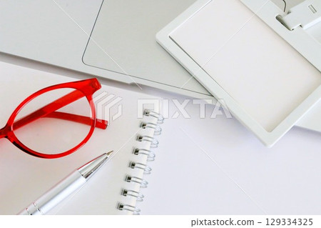 Business items: red glasses and employee ID card, copy space, white background, 3:2 129334325