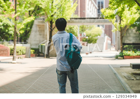 Male student walking on campus 129334949