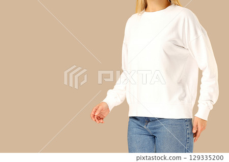 Model in a white sweatshirt and blue jeans Model in a white sweatshirt and blue jeans 129335200