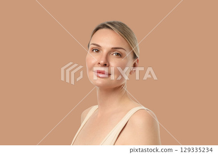 Woman poses confidently with a natural look and simple makeup 129335234