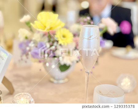 Image of a man sitting at a table at a wedding reception Image of a man sitting at a table at a wedding reception 129335378