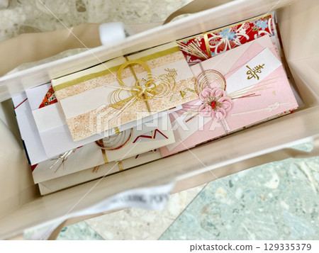 Many gift envelopes in paper bags 129335379