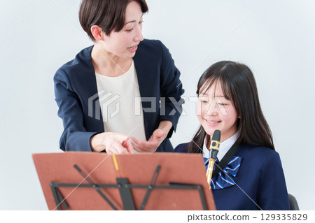 Music lesson teacher and students 129335829
