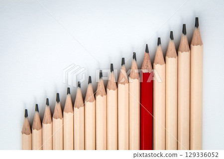 Standing Out from the Crowd. Unique Red Pencil Among Ordinary Pencils Standing Out from the Crowd. Unique Red Pencil Among Ordinary Pencils 129336052