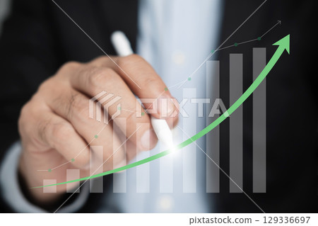 Businessman uses digital pen to draw a growing financial graph. Businessman uses digital pen to draw a growing financial graph. 129336697