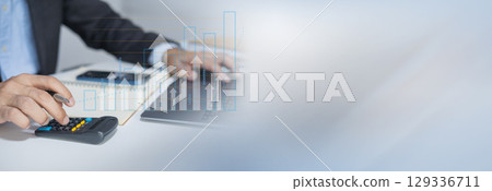 Businessman using laptop for analytics, finance and banking technology. 129336711