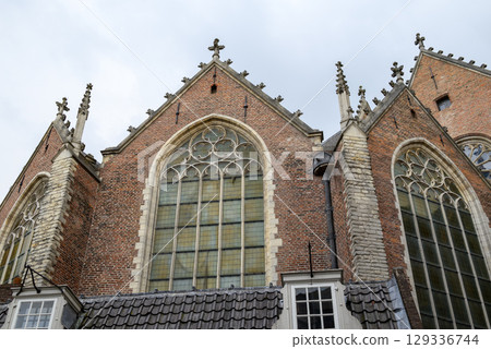 The Oude Kerk, Old Church is oldest building and church in De Wallen, main red-light district in Amsterdam, Netherlands 129336744