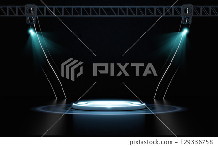 Empty dark stage with a glowing white round podium center, illuminated by two vibrant blue spotlights from an overhead metal truss structure. Ideal for product displays, presentations, or events. 129336758