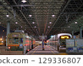 Tram running through the city at night 129336807