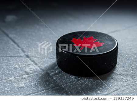 Canadian Hockey Puck on Ice Rink 129337249