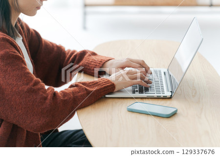 Women handling personal computers 129337676