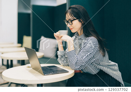 Middle woman working in a cafe Middle woman working in a cafe 129337702