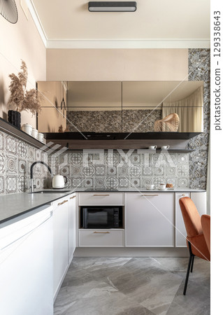 Modern Kitchen with Patterned Tiles and Elegant Dining Area Modern Kitchen with Patterned Tiles and Elegant Dining Area 129338643