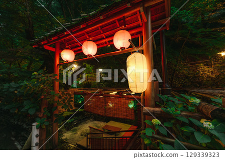 Kawadoko Dining with Traditional Yellow Lanterns in Kyoto Summer Evening 129339323