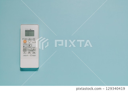 White Air Conditioner Remote Control on Blue Background, Climate Comfort 129340419