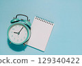 Alarm Clock and Notepad on Blue, Time Management and Planning 129340422