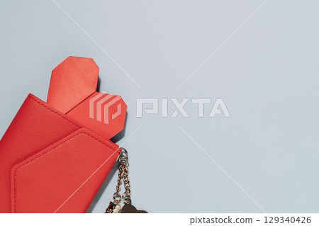 Red Wallet with Heart and Keychain on Blue Background 129340426