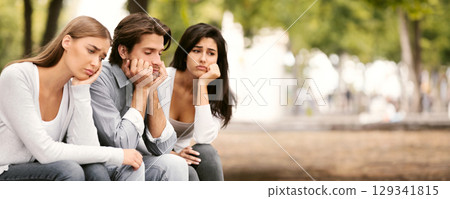Boredom. Three Bored Friends Sitting Sad On Bench In Park Spending Time Together In Park Outdoors. Selective Focus Boredom. Three Bored Friends Sitting Sad On Bench In Park Spending Time Together In Park Outdoors. Selective Focus 129341815
