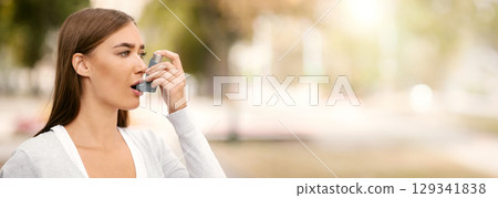 Asthma Concept. Girl Having Asthmatic Attack Using Inhaler Feeling Bad Walking Outside In City. Asthma Concept. Girl Having Asthmatic Attack Using Inhaler Feeling Bad Walking Outside In City. 129341838