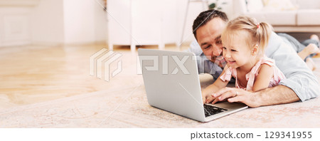Stay At Home Concept. Glad family using personal computer and lying on the floor in cozy apartment 129341955