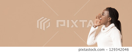 Black woman with braided hair actively shouts with enthusiasm, showcasing her expressive energy. She is dressed in a cozy white sweater, and her pose suggests a moment of engagement or communication Black woman with braided hair actively shouts with enthusiasm, showcasing her expressive energy. She is dressed in a cozy white sweater, and her pose suggests a moment of engagement or communication 129342046
