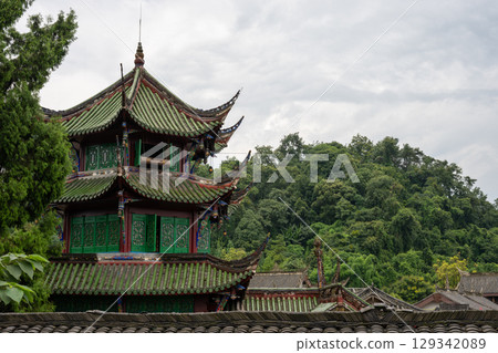 Vibrant traditional architecture against a lush green backdrop i Vibrant traditional architecture against a lush green backdrop i 129342089