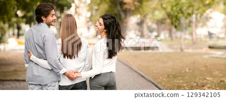 Cheating Husband Holding Hands With Wife's Best Friend Walking Together In Park Outside. Love Triangle Concept. Rear View 129342105