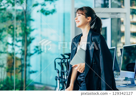 Business woman using a personal computer in the office 129342127