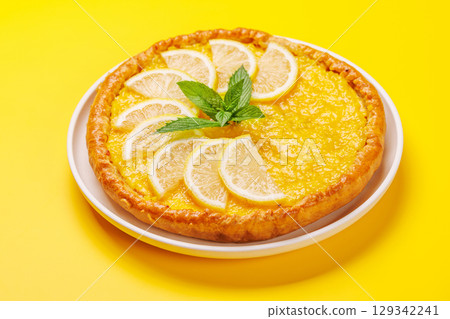 Delicious lemon tart with golden crust and smooth, glossy lemon filling 129342241