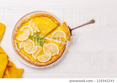 Delicious lemon tart with golden crust and smooth, glossy lemon filling 129342243