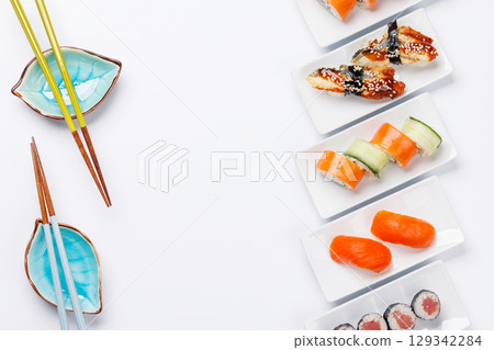 Assorted sushi and maki rolls beautifully arranged on plates 129342284