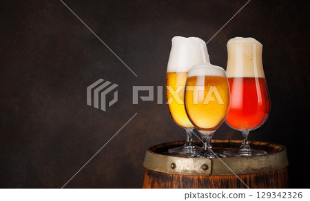 A selection of various beer glasses filled with different types of beer A selection of various beer glasses filled with different types of beer 129342326