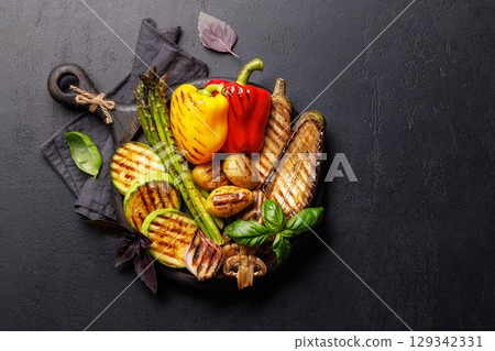 Assorted grilled vegetables including bell peppers, zucchini, eggplant, and asparagus 129342331