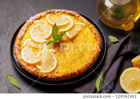 Delicious lemon tart with golden crust and smooth, glossy lemon filling 129342481