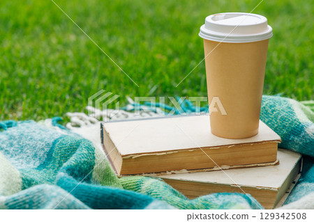 Picnic on a lawn with books and coffee 129342508