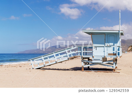 Lifeguard tower on a California ocean beach with golden sand and waves 129342559