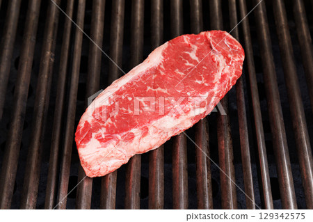 Juicy steak on a grill 129342575