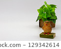 Owl figurine on white background 129342614