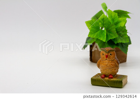 Owl figurine on white background 129342614