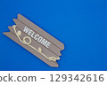 Welcome sign on blue background 129342616