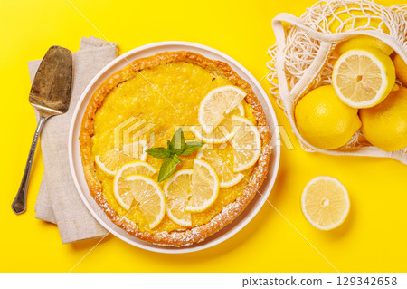 Delicious lemon tart with golden crust and smooth, glossy lemon filling 129342658