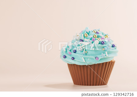 Festive cupcake topped with swirled frosting Festive cupcake topped with swirled frosting 129342716