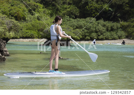 Cute woman enjoying SUP 129342857