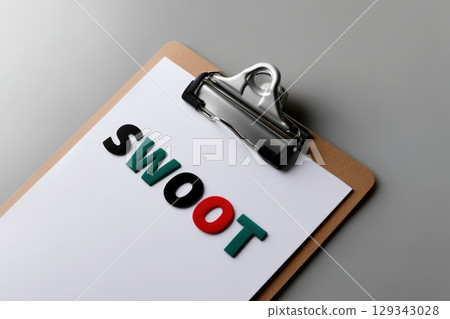 Informative SWOT analysis on clipboard emphasizes strategic planning in business 129343028