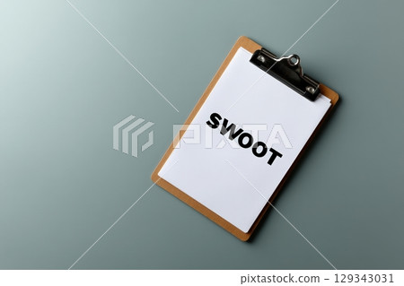 SWOT analysis presented on a clipboard in a neutral flat environment for strategic planning 129343031