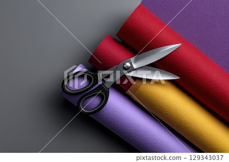 Crafting with layered paper cut shapes and scissors on a flat surface 129343037