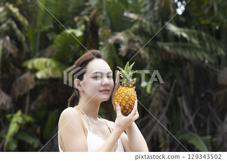 Woman with pineapple Woman with pineapple 129343502
