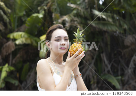 Woman with pineapple Woman with pineapple 129343503